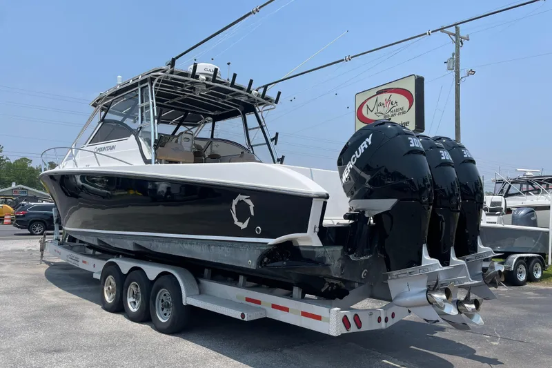 Slide: The Image of 2007 Fountain 38 Sportfish Cruiser OB with triple Mercury engines on trailer. - 5