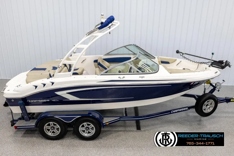 Slide: The Image of 2015 Chaparral 19 H2O Ski & Fish boat on trailer in showroom. - 1