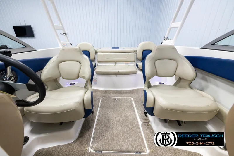 Slide: The Image of Interior of 2015 Chaparral 19 H2O Ski & Fish boat with beige seating and steering wheel. - 17