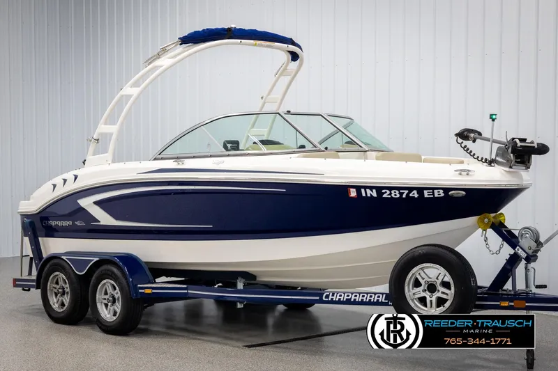 Slide: The Image of 2015 Chaparral 19 H2O Ski & Fish boat on trailer, blue and white design. - 2