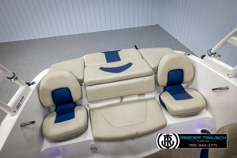 Slide: The Image of 2015 Chaparral 19 H2O Ski & Fish boat interior with beige and blue seating. - 21