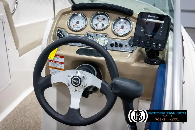 Slide: The Image of 2015 Chaparral 19 H2O Ski & Fish dashboard with steering wheel and Raymarine display. - 26