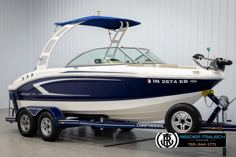 Slide: The Image of 2015 Chaparral 19 H2O Ski & Fish boat on trailer, blue and white design. - 3