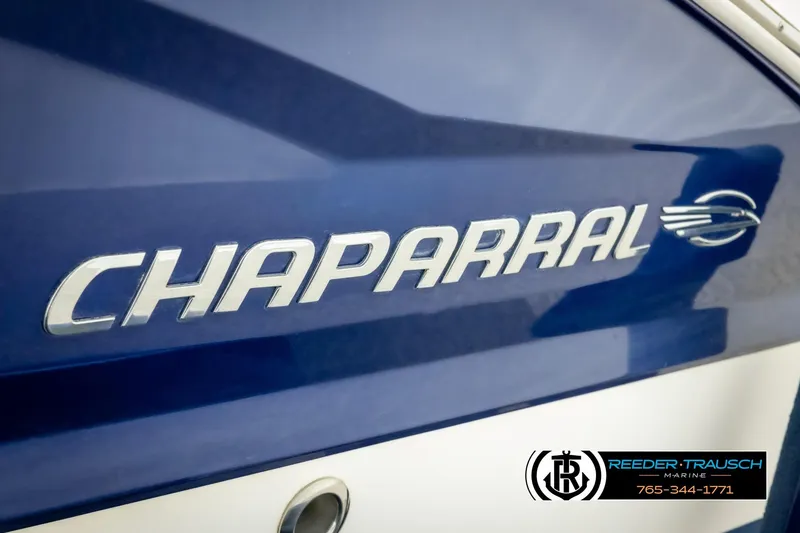 Slide: The Image of 2015 Chaparral 19 H2O Ski & Fish boat logo on blue hull. - 47