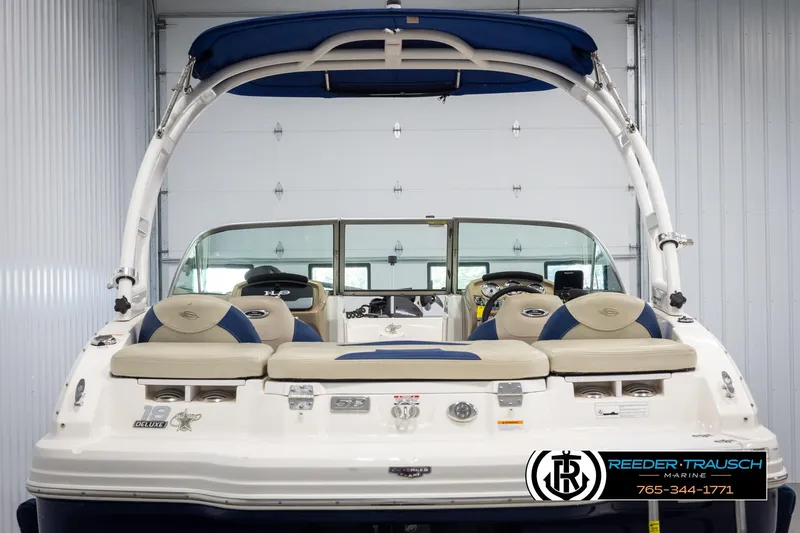Slide: The Image of 2015 Chaparral 19 H2O Ski & Fish boat, rear view in a garage setting. - 7