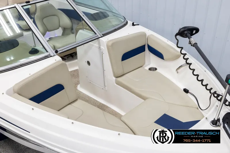 Slide: The Image of 2015 Chaparral 19 H2O Ski & Fish boat interior with beige seating and trolling motor. - 9