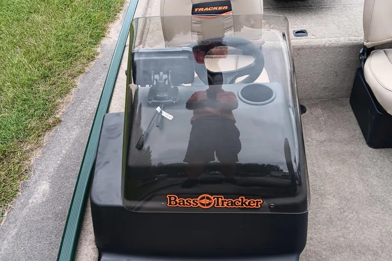 Slide: The Image of 2026 Tracker Bass Tracker Classic Limited boat console with steering wheel and logo. - 10