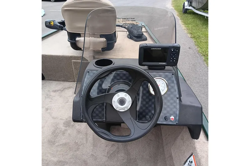 Slide: The Image of 2026 Tracker Bass Tracker Classic Limited dashboard with steering wheel and Lowrance fishfinder. - 11