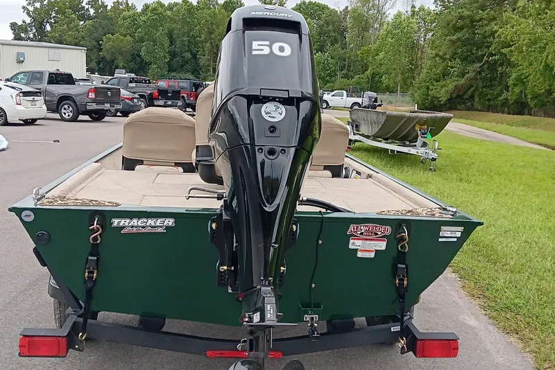 Slide: The Image of 2026 Tracker Bass Tracker Classic Limited boat with Mercury 50 engine, parked outdoors. - 5
