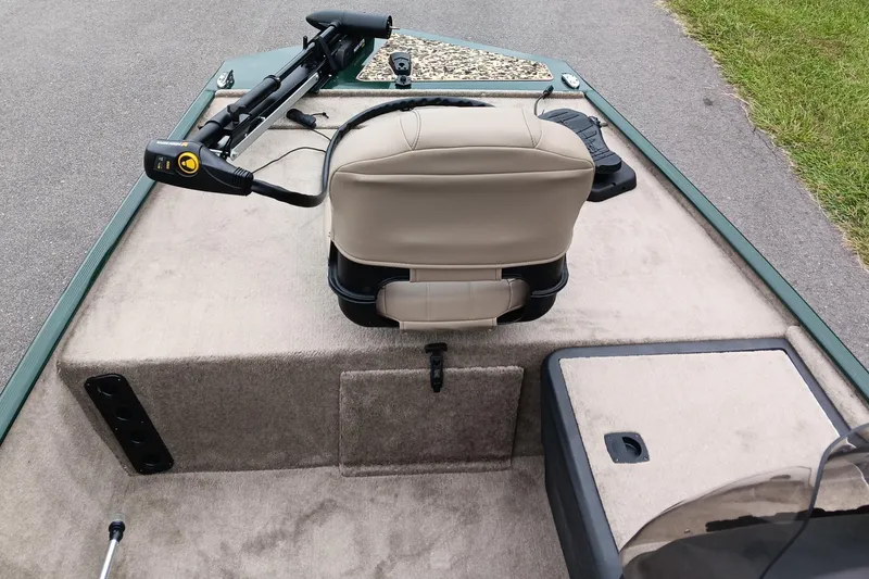 Slide: The Image of 2026 Tracker Bass Tracker Classic Limited boat interior with beige seating and trolling motor. - 8