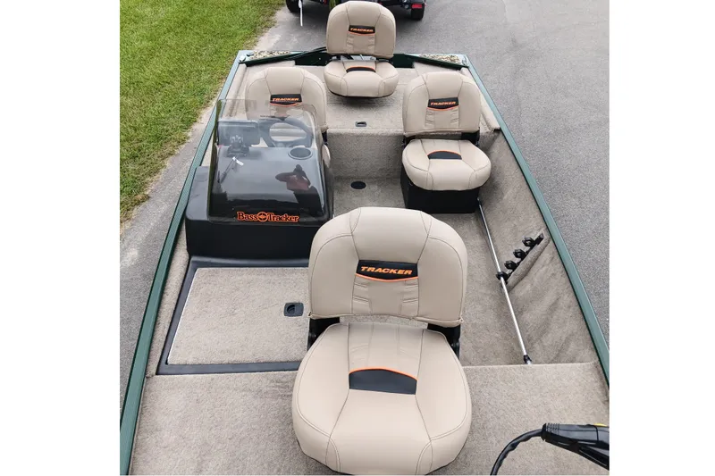 Slide: The Image of 2026 Tracker Bass Tracker Classic Limited boat interior with beige seats and steering console. - 9