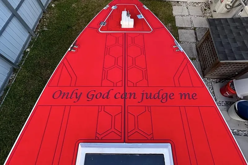 Slide: The Image of 1980 Wellcraft Scarab 302 boat with red deck, "Only God can judge me" text. - 2