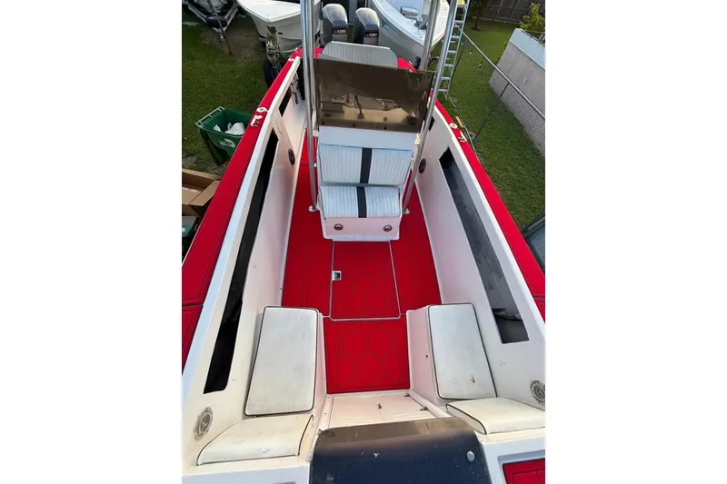 Slide: The Image of 1980 Wellcraft Scarab 302 boat interior with red flooring and white seating. - 3