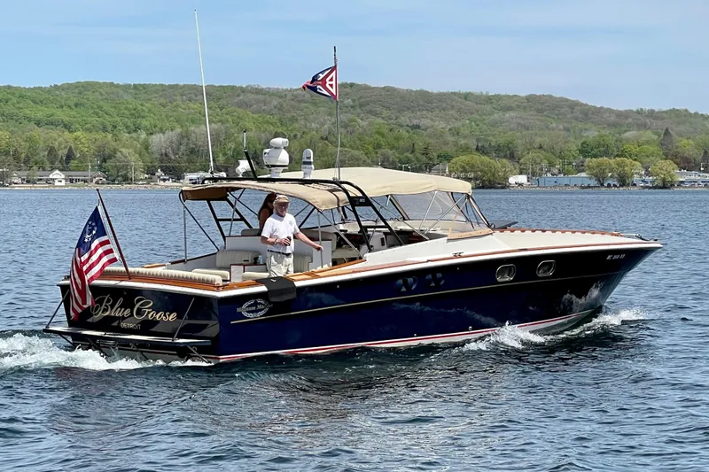 Slide: The Image of 1979 Magnum 38 Sport boat named "Blue Goose" cruising on a scenic lake. - 0