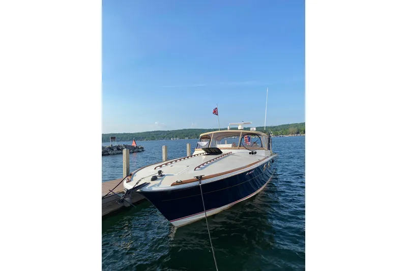 Slide: The Image of 1979 Magnum 38 Sport boat on stands, parked outdoors under clear blue sky. - 1