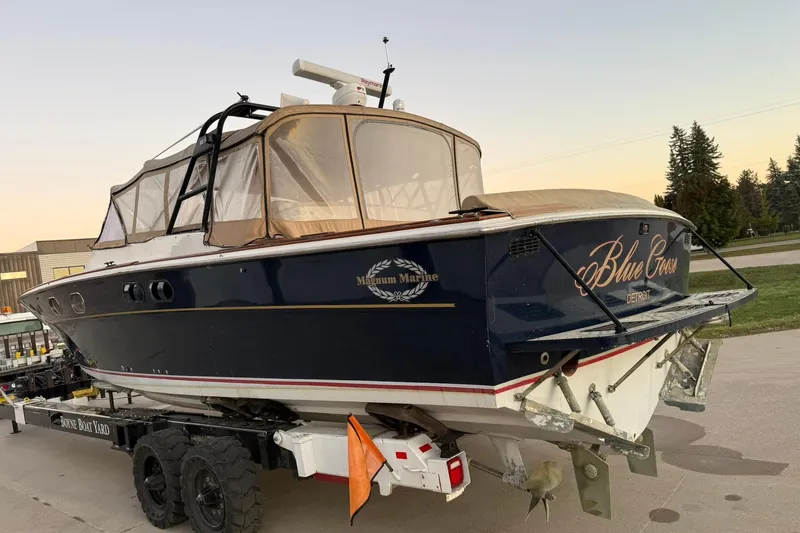 Slide: The Image of 1979 Magnum 38 Sport boat named "Blue Goose" on a trailer at sunset. - 10