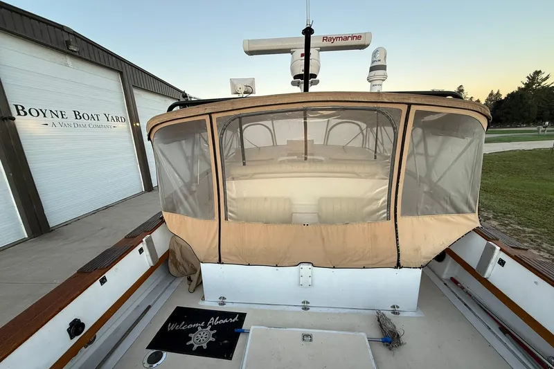 Slide: The Image of 1979 Magnum 38 Sport boat at Boyne Boat Yard with covered seating area. - 12