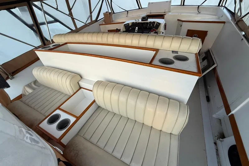 Slide: The Image of Interior of a 1979 Magnum 38 Sport boat with cream seating and wood accents. - 13