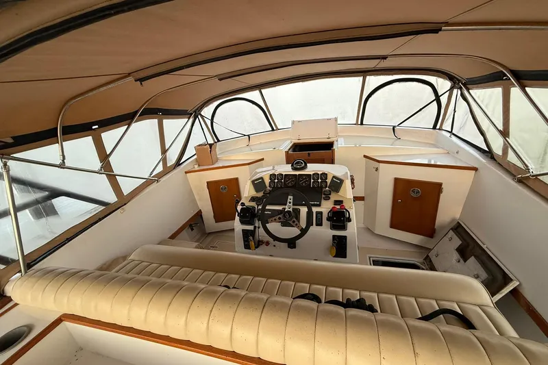 Slide: The Image of Interior of a 1979 Magnum 38 Sport boat with steering controls and seating. - 14