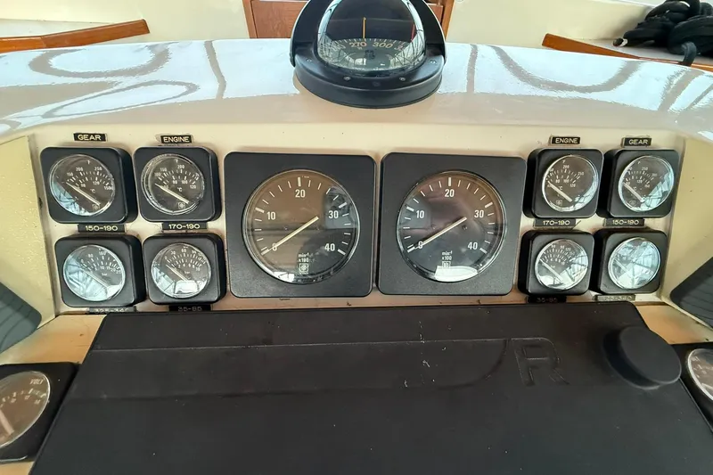 Slide: The Image of Dashboard of a 1979 Magnum 38 Sport boat with various gauges and controls. - 17