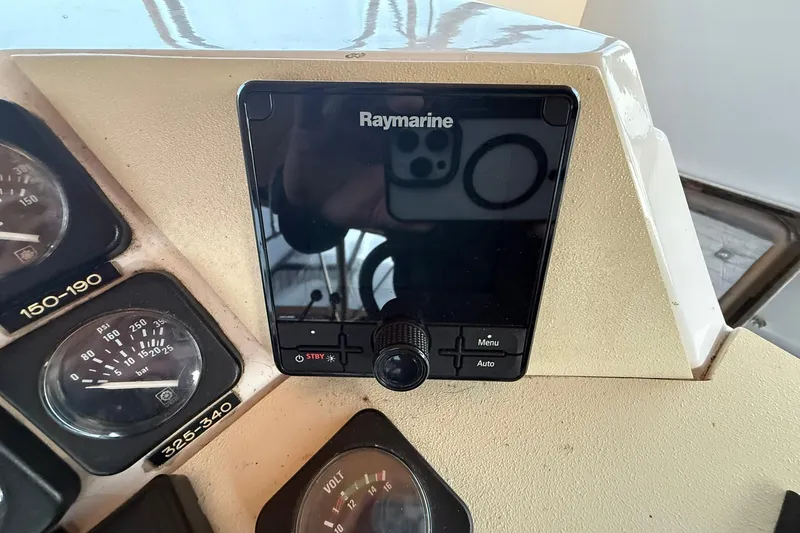 Slide: The Image of Control panel of a 1979 Magnum 38 Sport boat with Raymarine display and gauges. - 18