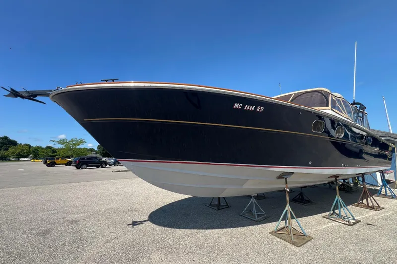 Slide: The Image of Vintage 1979 Magnum 38 Sport boat docked on a serene lake. - 2