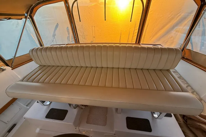 Slide: The Image of Vintage 1979 Magnum 38 Sport boat interior with beige leather seating and sunlit windows. - 21