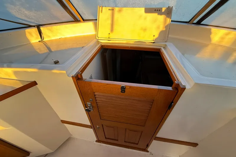 Slide: The Image of 1979 Magnum 38 Sport boat interior with wooden door and sunlight reflections. - 25
