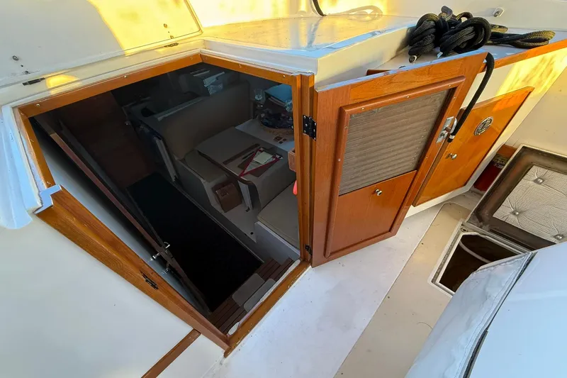Slide: The Image of Interior view of a 1979 Magnum 38 Sport boat, featuring wooden cabinetry and seating area. - 26