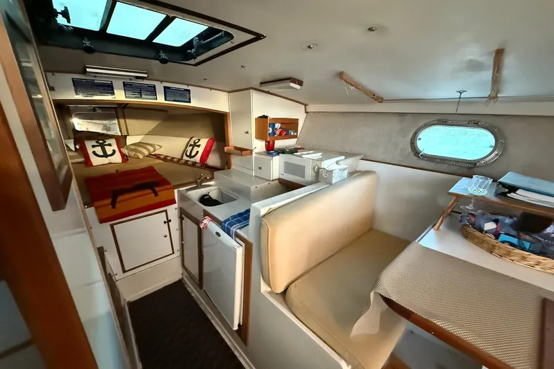 Slide: The Image of Interior of a 1979 Magnum 38 Sport boat with cozy seating and nautical decor. - 30