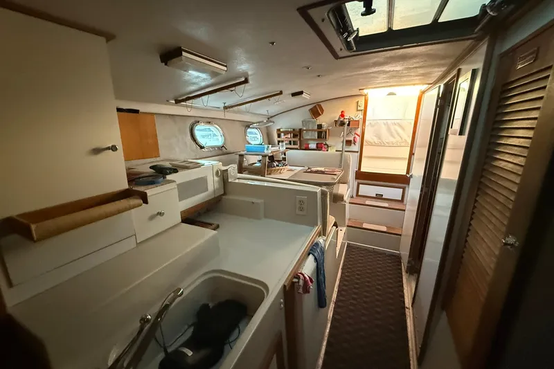 Slide: The Image of Interior of 1979 Magnum 38 Sport boat with kitchen and seating area. - 32