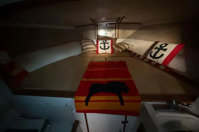 Slide: The Image of Cozy cabin interior of 1979 Magnum 38 Sport boat with nautical-themed decor. - 33