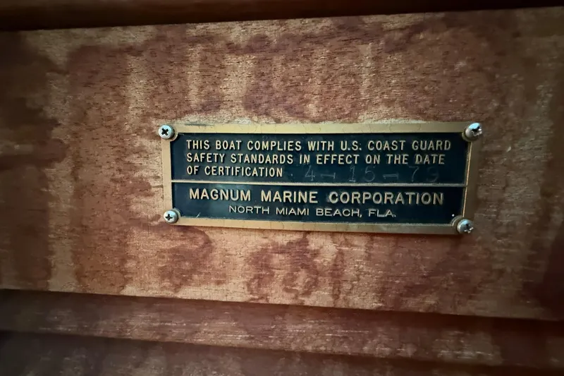 Slide: The Image of Plaque on 1979 Magnum 38 Sport boat, certifying U.S. Coast Guard safety compliance. - 34