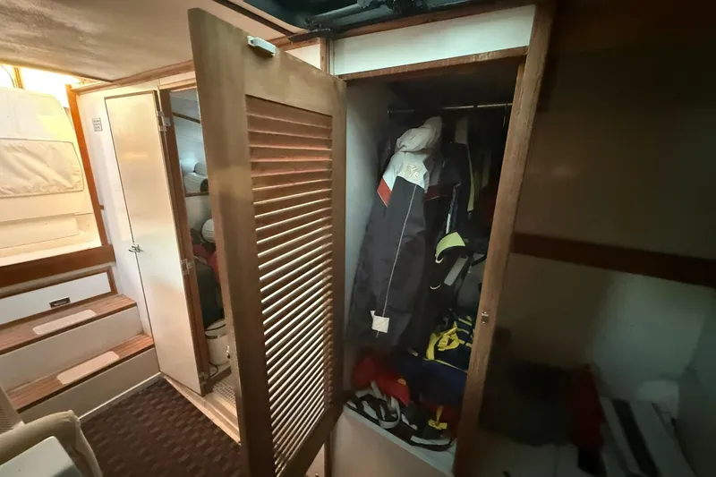 Slide: The Image of Interior of a 1979 Magnum 38 Sport boat with open closet and hanging jackets. - 35