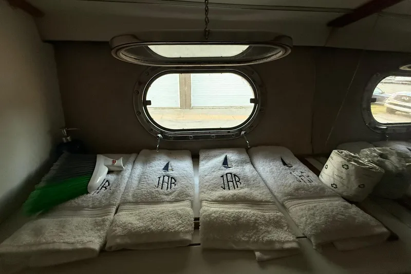 Slide: The Image of Interior of 1979 Magnum 38 Sport yacht with embroidered towels and porthole view. - 37