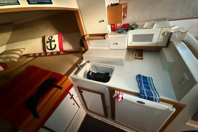 Slide: The Image of Interior of a 1979 Magnum 38 Sport boat with cozy cabin and kitchenette. - 38