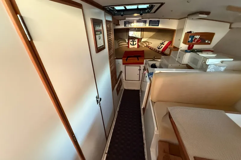Slide: The Image of Interior of a 1979 Magnum 38 Sport boat with cozy seating and nautical decor. - 39