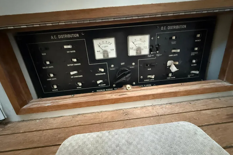 Slide: The Image of Electrical control panel of a 1979 Magnum 38 Sport boat, featuring AC and DC distribution. - 40
