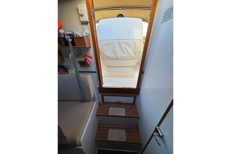 Slide: The Image of Interior view of 1979 Magnum 38 Sport boat, featuring wooden steps and seating area. - 41