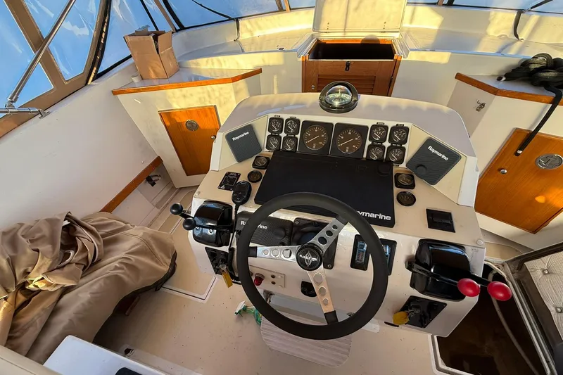 Slide: The Image of Cockpit of 1979 Magnum 38 Sport boat with steering wheel and navigation instruments. - 44