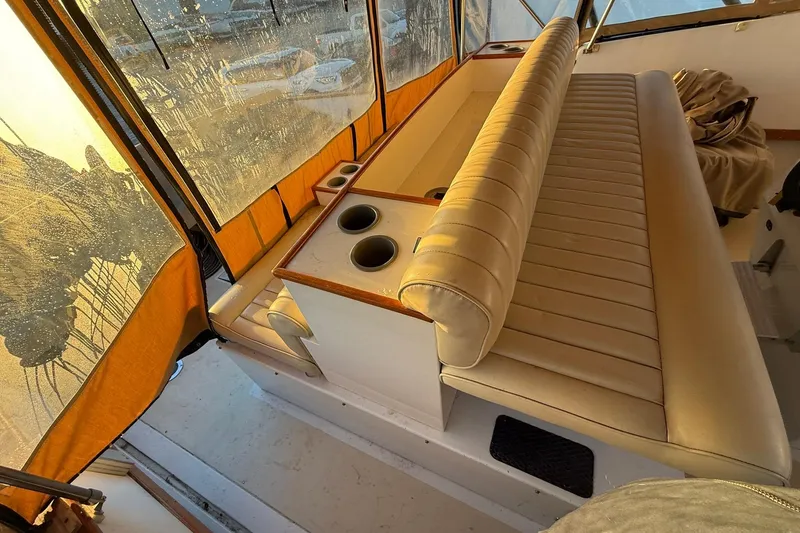Slide: The Image of Interior of a 1979 Magnum 38 Sport boat with beige seating and cup holders. - 45