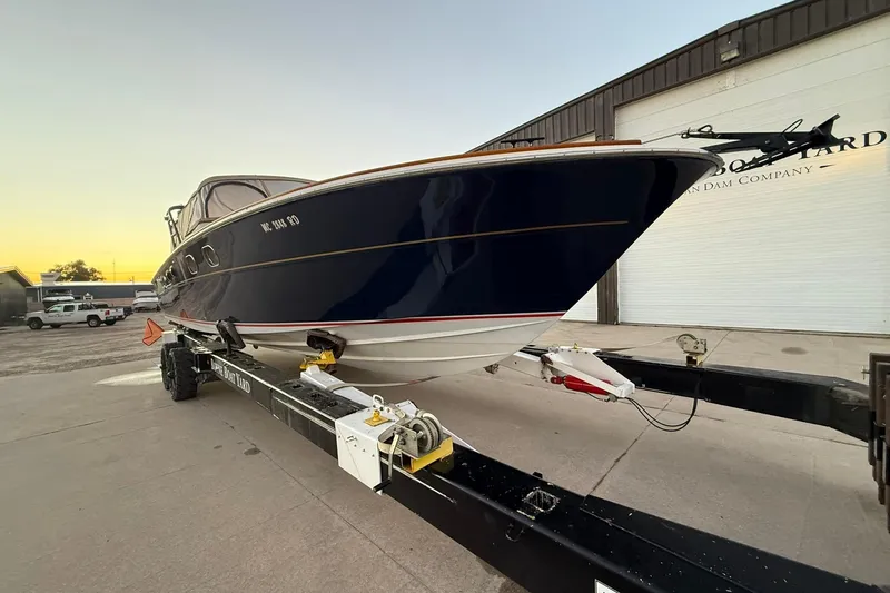 Slide: The Image of 1979 Magnum 38 Sport boat on trailer at Boyne Boat Yard, parked outdoors. - 6
