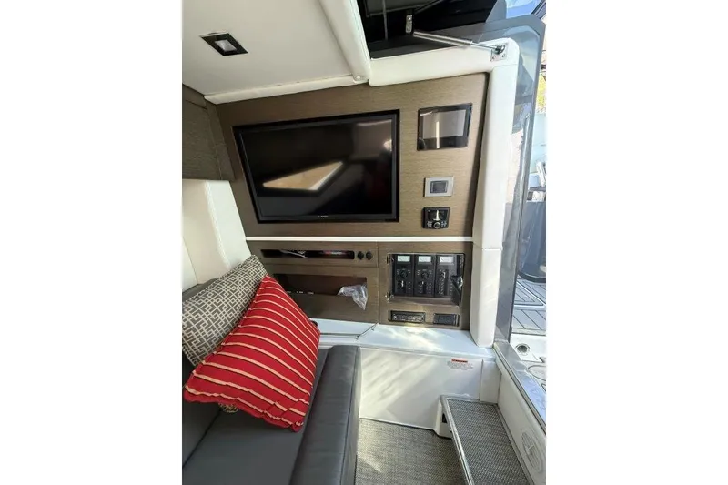 Slide: The Image of Interior of 2019 Cobalt A36 boat with TV, control panel, and cushions. - 22