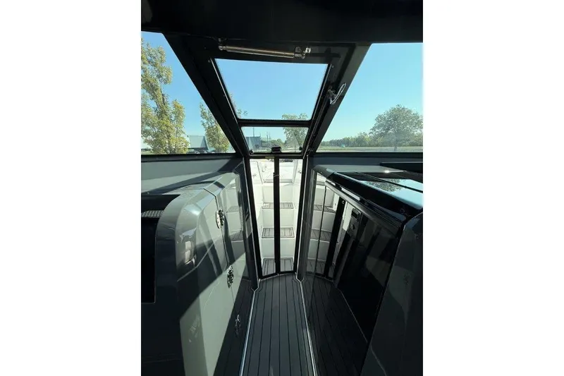 Slide: The Image of Interior view of a 2019 Cobalt A36 boat with sleek design and glass door. - 25