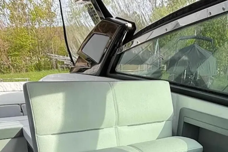 Slide: The Image of Interior of a 2019 Cobalt A36 boat with light green seating and large windows. - 26