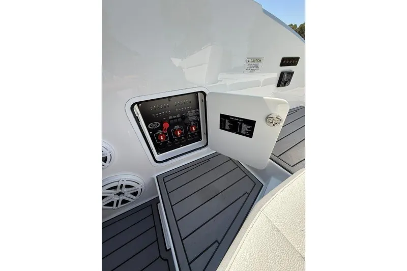 Slide: The Image of 2019 Cobalt A36 boat electrical panel with open access door and speakers. - 28