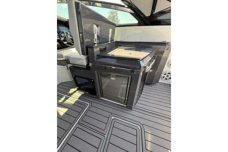 Slide: The Image of 2019 Cobalt A36 boat interior with sleek kitchenette and modern flooring. - 31