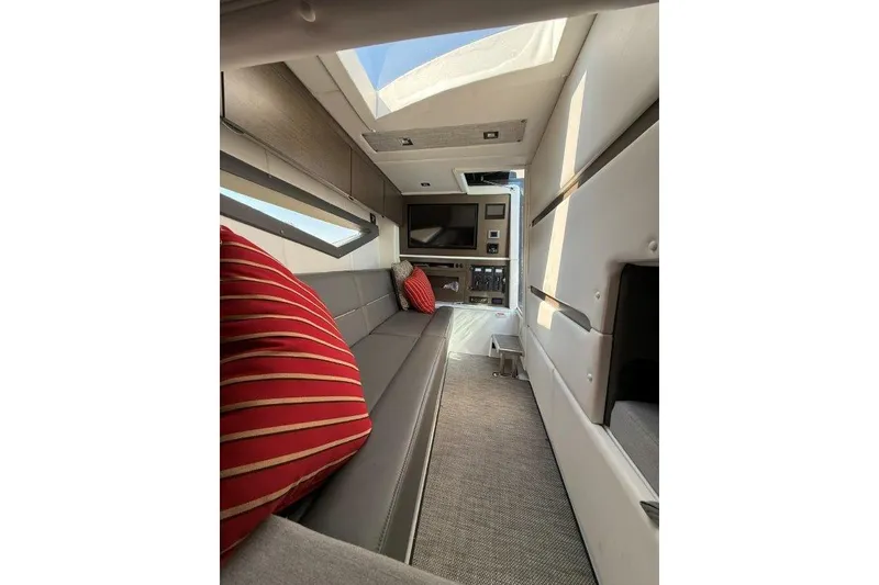 Slide: The Image of Interior of 2019 Cobalt A36 boat with modern seating and red-striped pillows. - 32