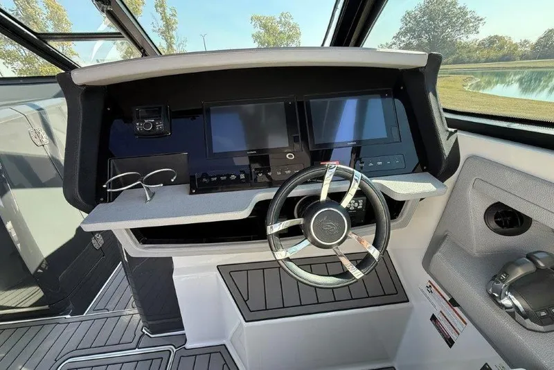 Slide: The Image of 2019 Cobalt A36 boat dashboard with dual screens and modern steering wheel. - 35