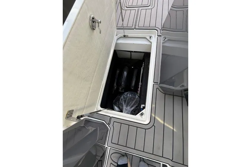 Slide: The Image of 2019 Cobalt A36 boat storage compartment with open hatch on deck. - 38
